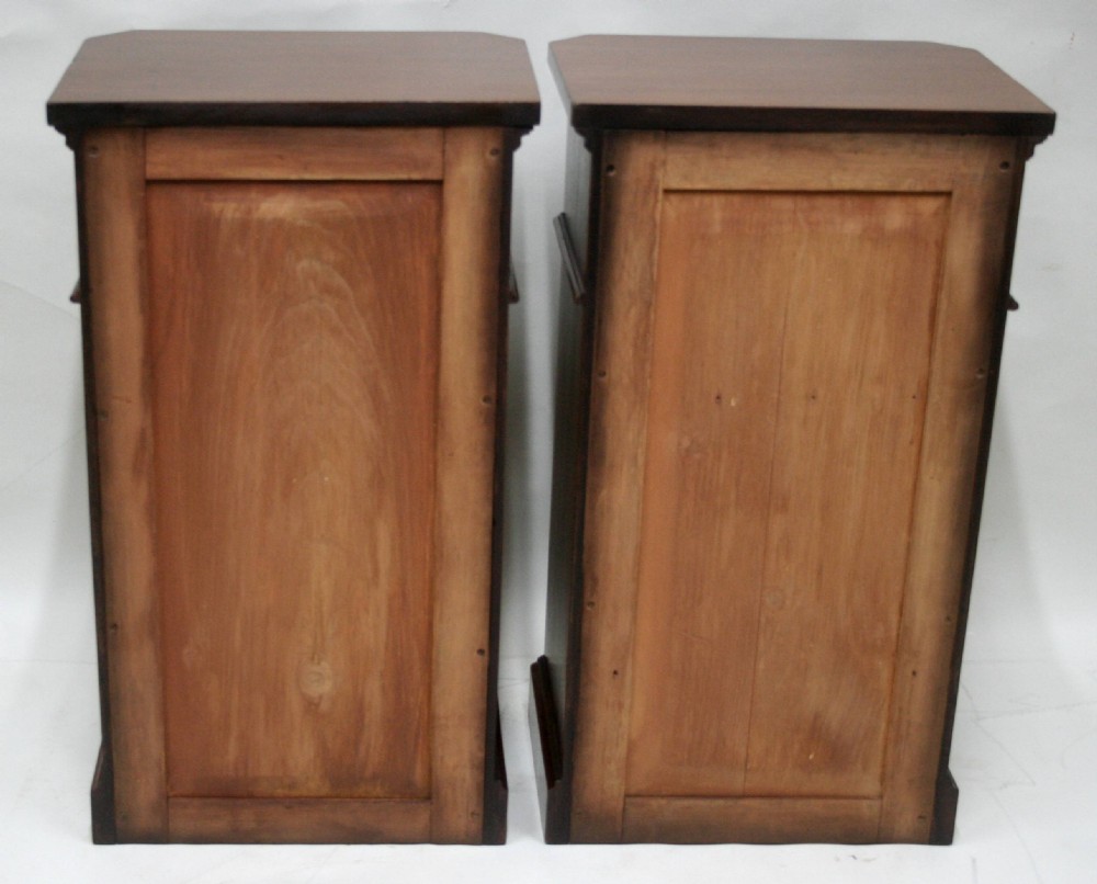 A matching pair of mahogany bedside cabinets featuring canted corners, single top drawers, cupboard doors, turned wooden knobs, and plinth bases. View VIII