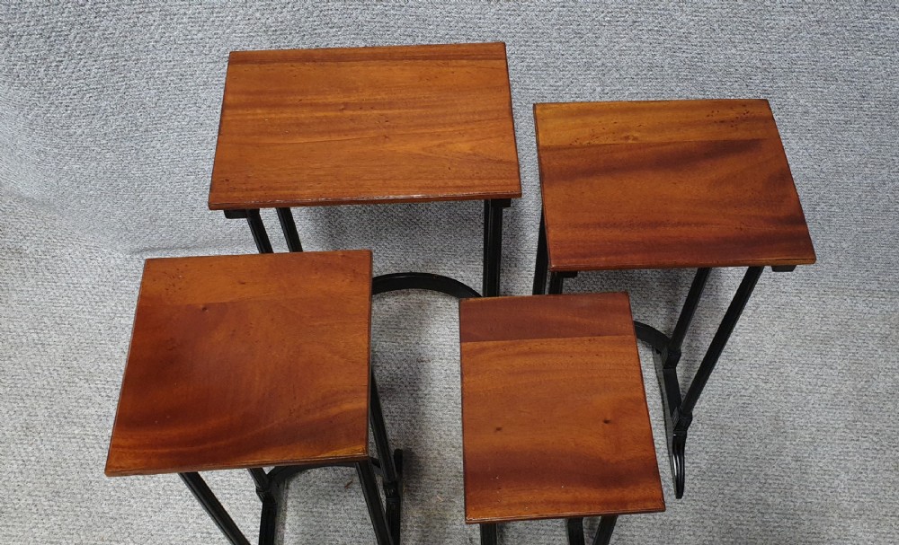 A set of four graduated mahogany nesting tables featuring rectangular tops, slender turned legs, and trestle feet. View II