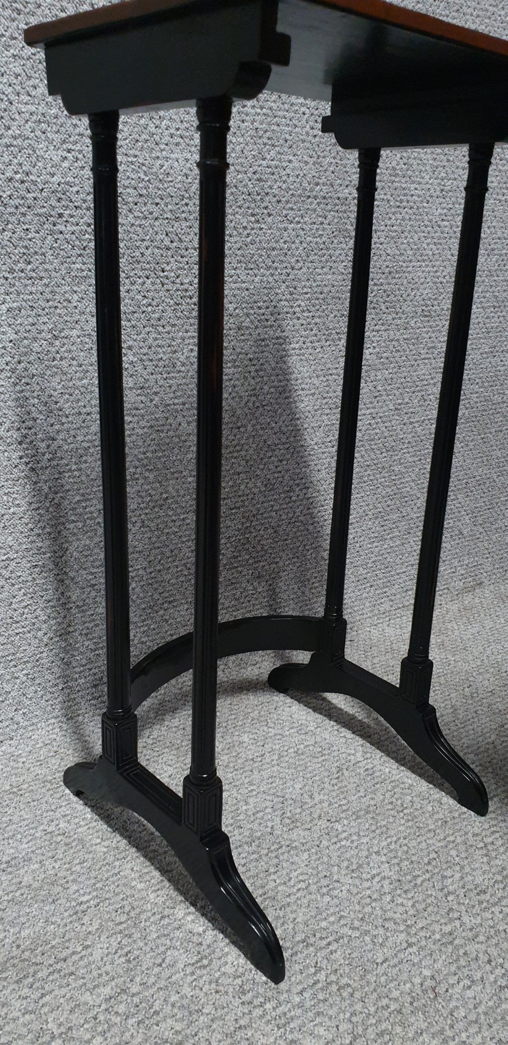 A set of four graduated mahogany nesting tables featuring rectangular tops, slender turned legs, and trestle feet. View IV
