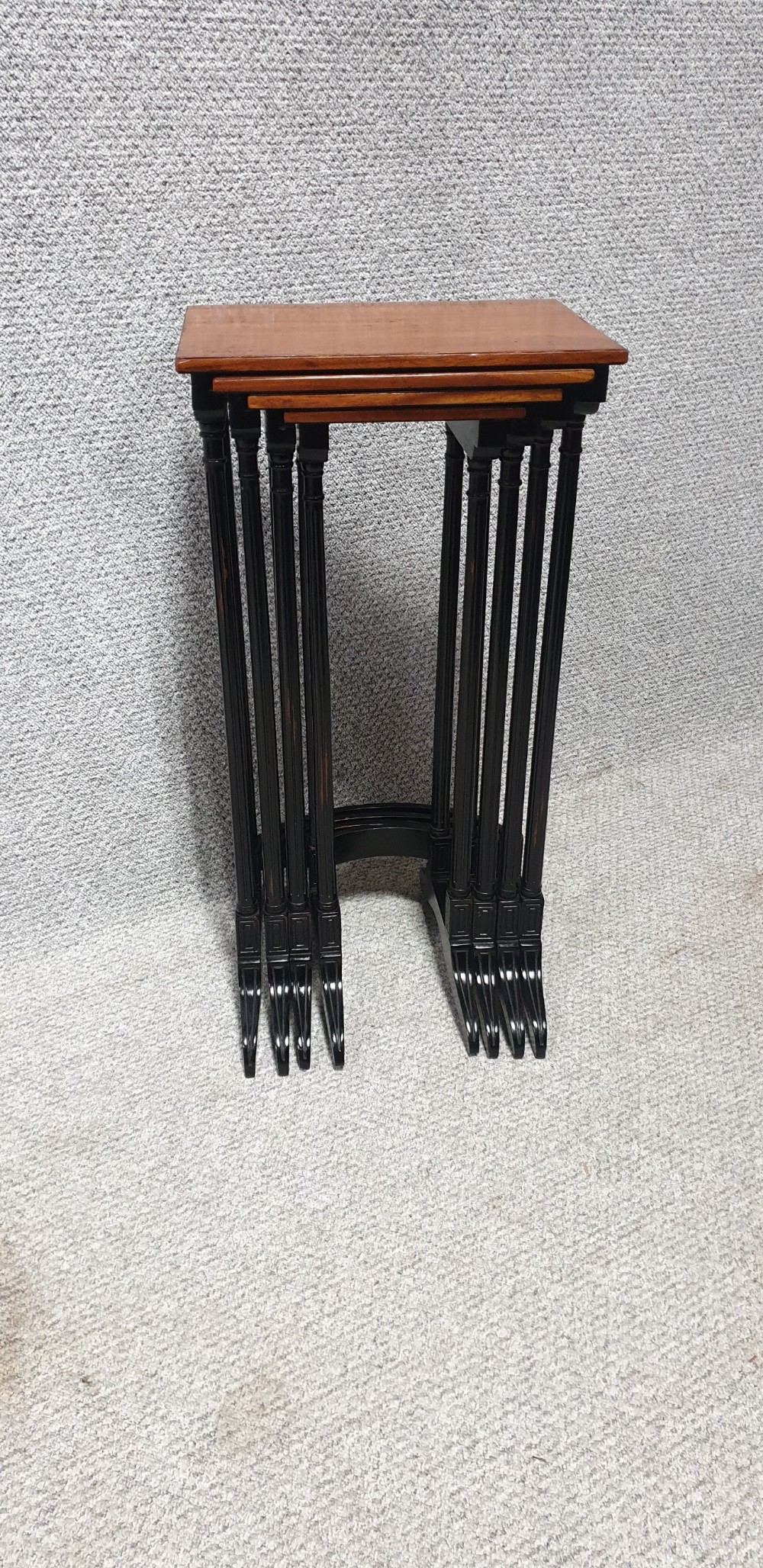 A set of four graduated mahogany nesting tables featuring rectangular tops, slender turned legs, and trestle feet. View VIII