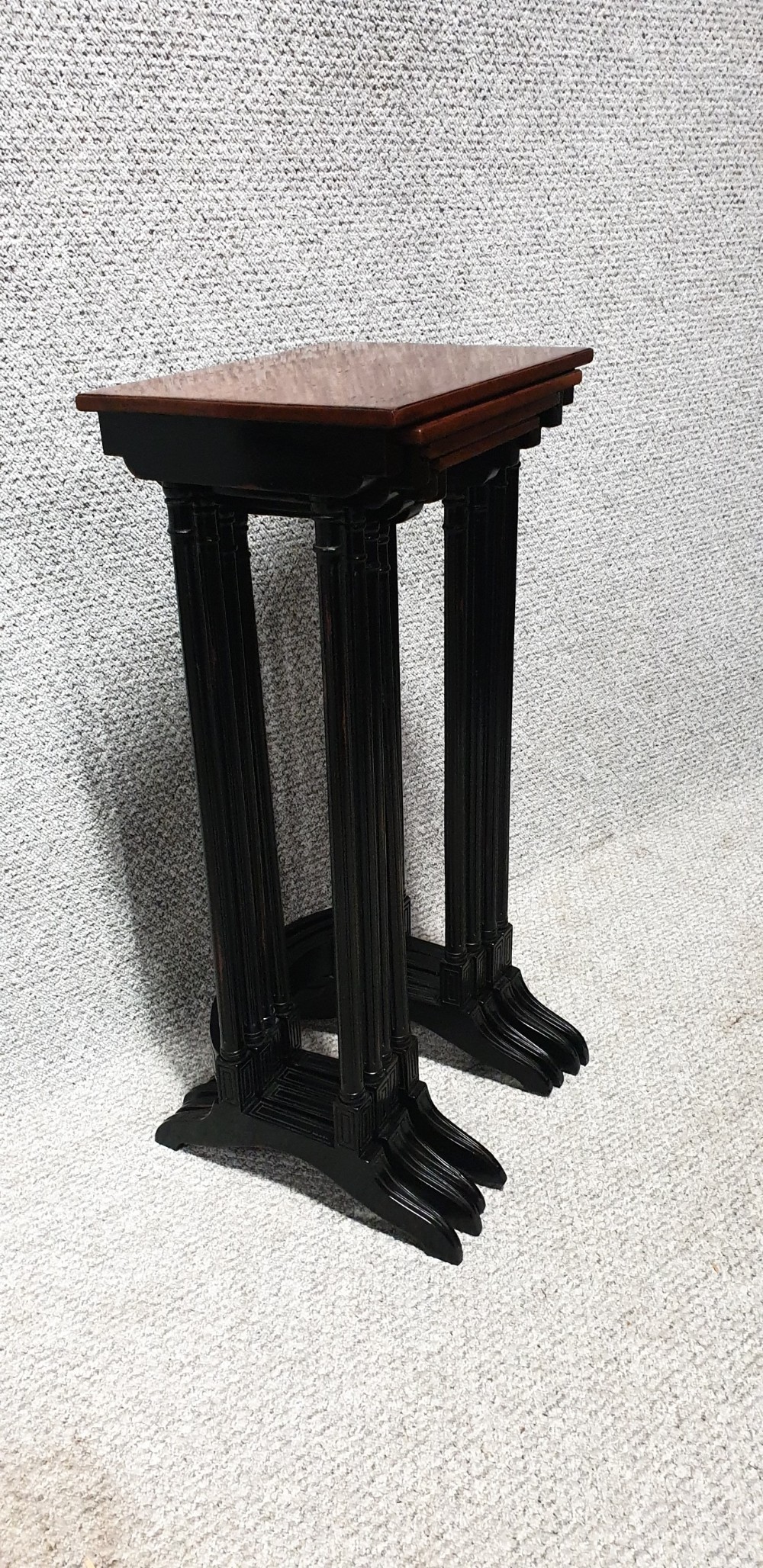 A set of four graduated mahogany nesting tables featuring rectangular tops, slender turned legs, and trestle feet. View IX