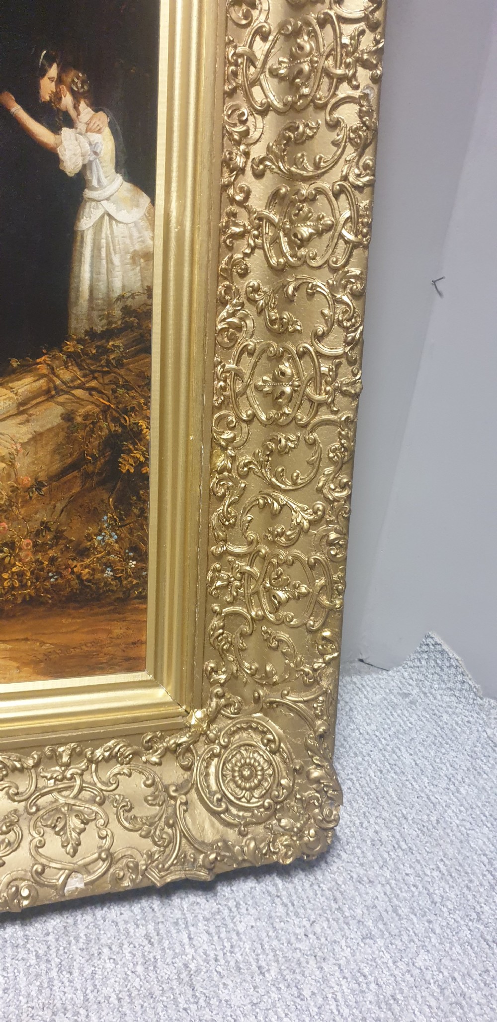 A large Victorian gilded picture frame with ornate relief moulding containing a historical narrative print. View VI