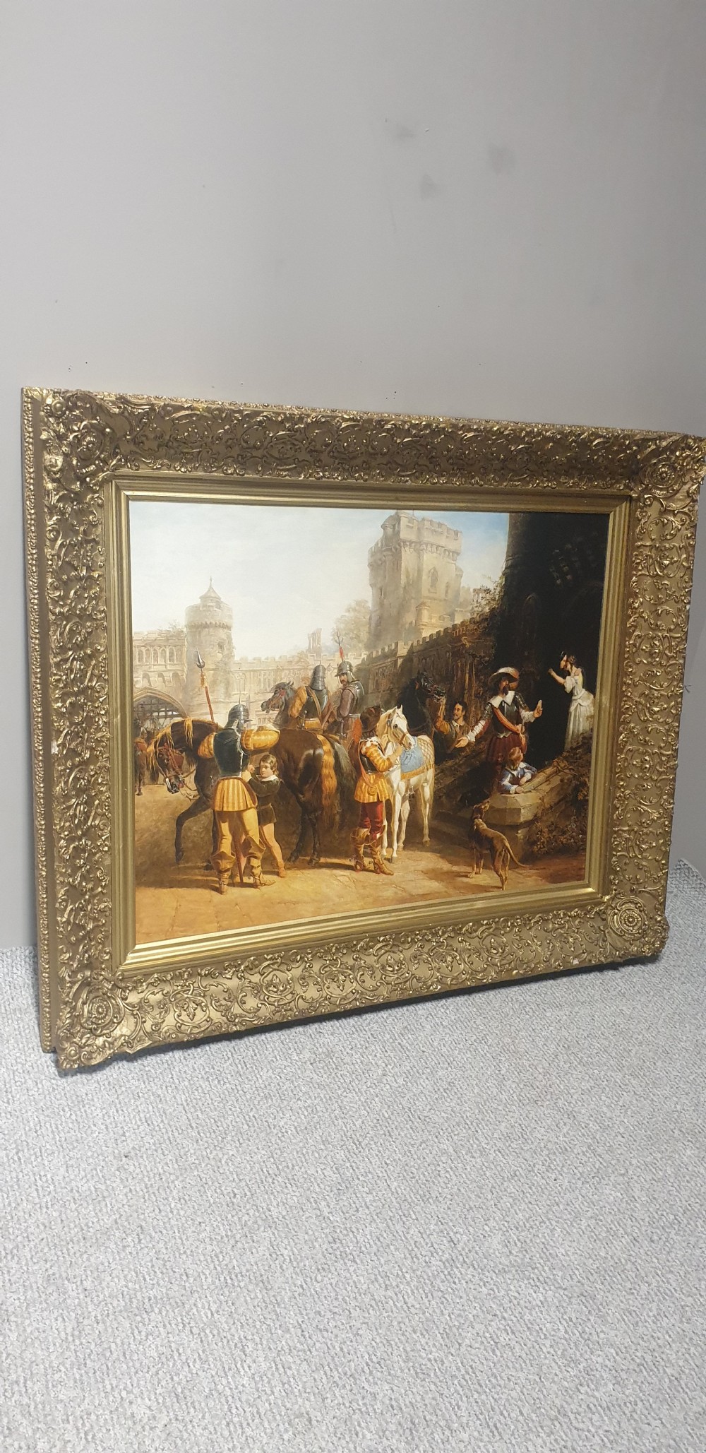 A large Victorian gilded picture frame with ornate relief moulding containing a historical narrative print. View VIII