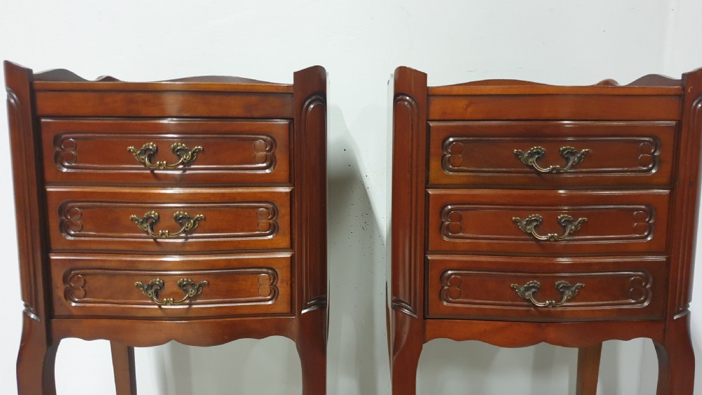 A matching pair of tall French mahogany bedside chests featuring three drawers with brass handles and slender cabriole legs. View III