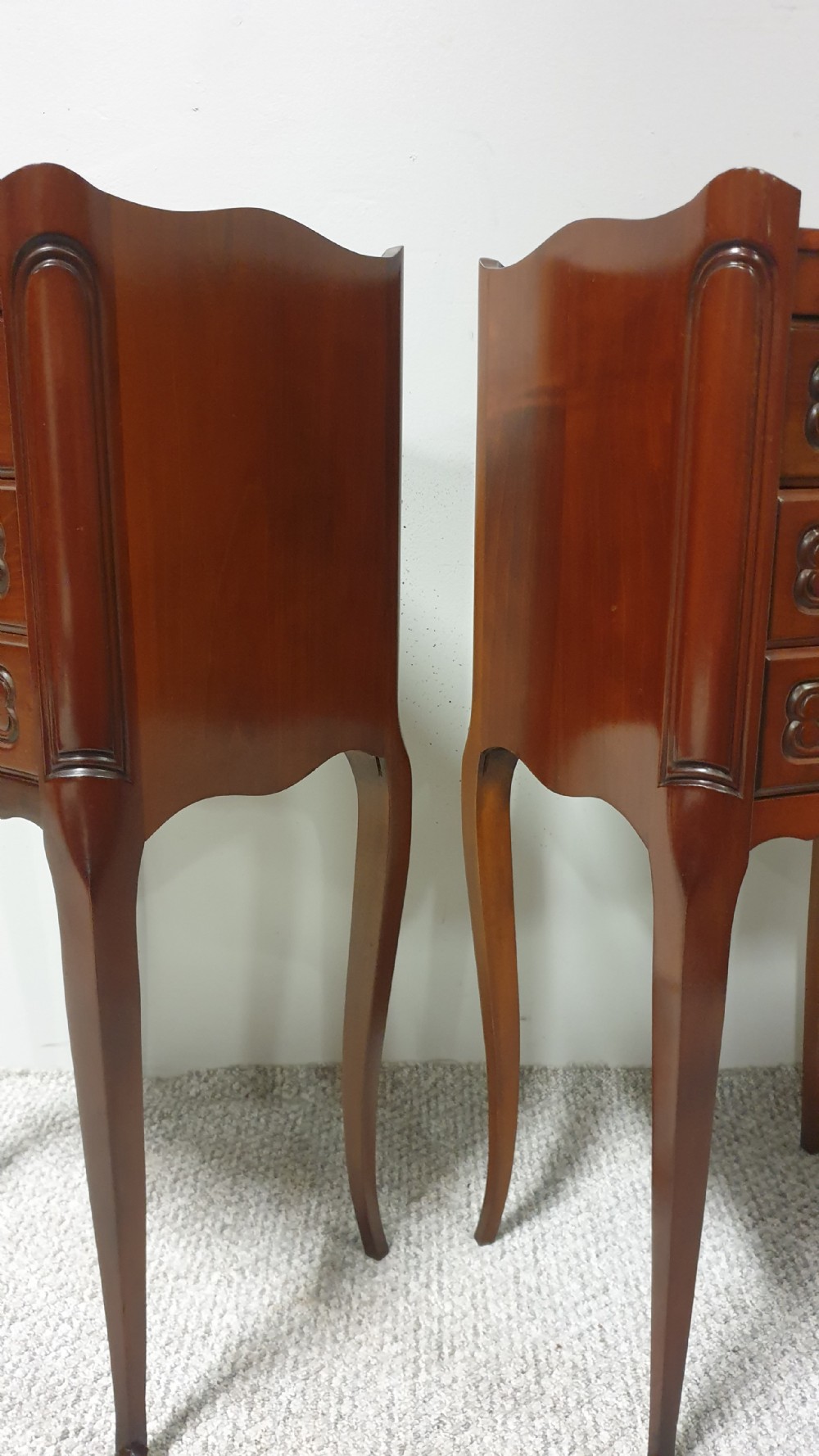 A matching pair of tall French mahogany bedside chests featuring three drawers with brass handles and slender cabriole legs. View VIII