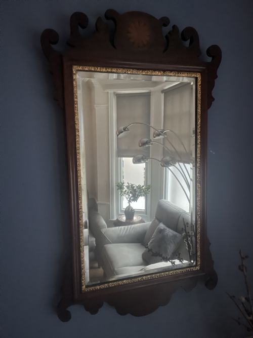 A antique wall mirror .