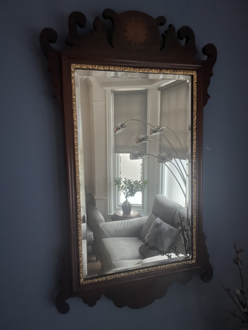 A dark mahogany rectangular wall mirror featuring fretwork scroll cresting with a central inlaid shell motif and a gilded inner frame slip.