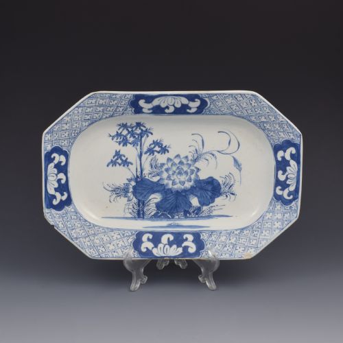 fig 1. An 18th-century octagonal blue and white soft-paste porcelain serving dish decorated with a central lotus and bamboo design within a diaper border.