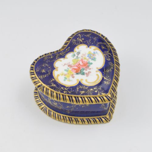 fig 1. A heart-shaped cobalt blue porcelain jewellery box featuring a hand-painted floral cartouche and detailed gilding along ribbed edges.