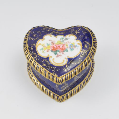 fig 2. A heart-shaped cobalt blue porcelain jewellery box featuring a hand-painted floral cartouche and detailed gilding along ribbed edges.