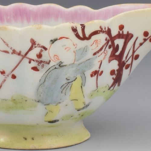 A small 18th-century soft-paste porcelain sauce boat featuring a scalloped fluted rim, loop handle, and hand-painted Chinoiserie figures with a pink interior border. View XI