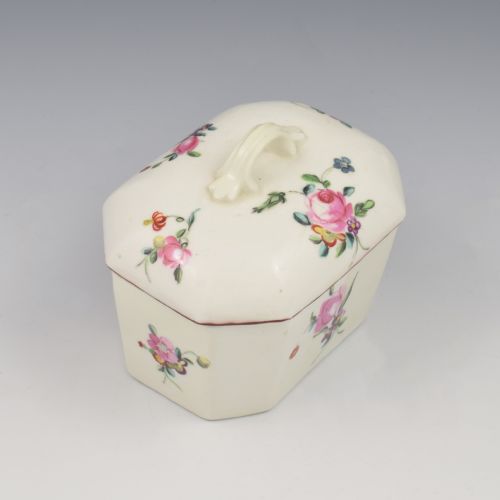 fig 2. An 18th-century off-white porcelain butter tub with a fitted cover, top handle, and hand-painted floral motifs.