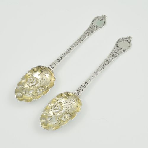 fig 1. A pair of William III sterling silver dognose spoons featuring chased floral stems and gilded, scalloped bowls.