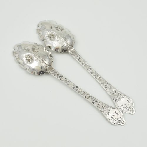 fig 2. A pair of William III sterling silver dognose spoons featuring chased floral stems and gilded, scalloped bowls.