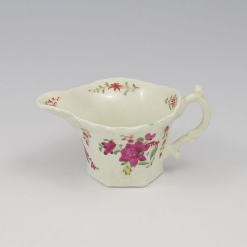 fig 1. An 18th-century soft-paste porcelain hexagonal sauce boat featuring hand-painted pink floral sprays and a molded scroll handle.