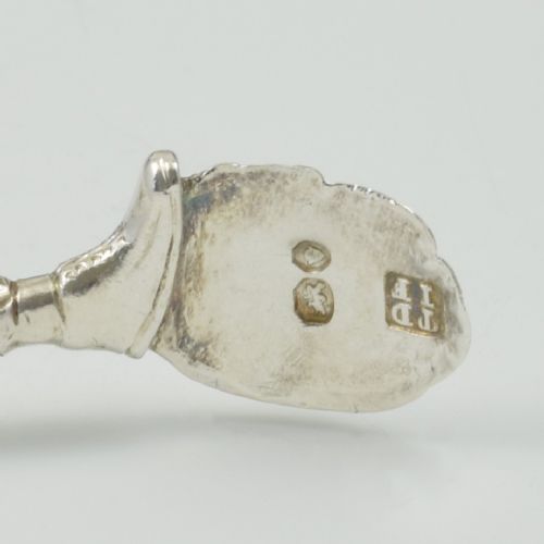 A George IV sterling silver novelty sugar tong designed as a Harlequin figure holding circular ring handles above its head. View XIV