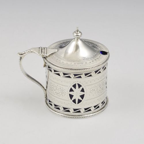 fig 1. A Victorian silver drum mustard pot with pierced fretwork, bright-cut engraving, a hinged lid, and a cobalt blue glass liner.