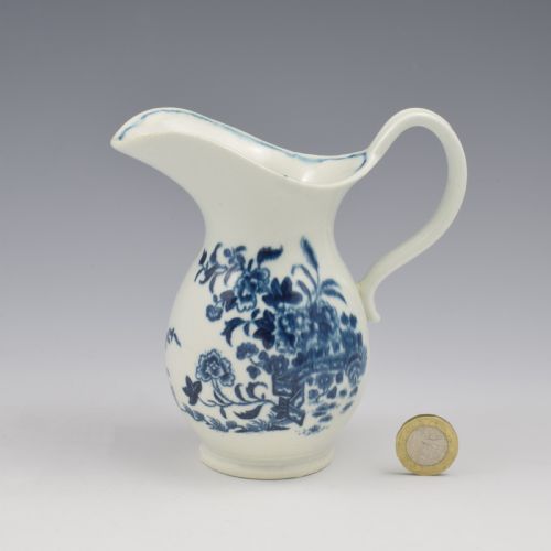 fig 1. An 18th-century blue and white Worcester porcelain milk ewer featuring a flared spout, loop handle, and hand-painted floral motifs.