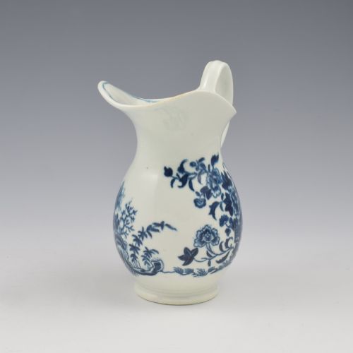 fig 2. An 18th-century blue and white Worcester porcelain milk ewer featuring a flared spout, loop handle, and hand-painted floral motifs.