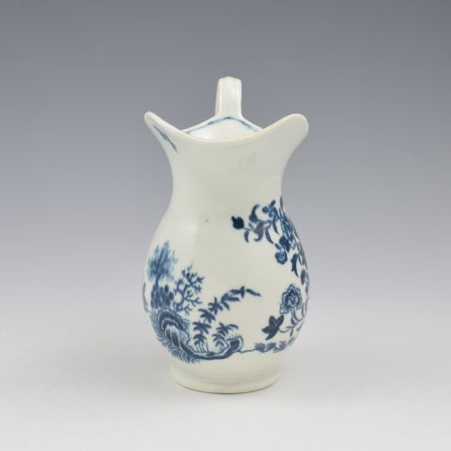 fig 3. An 18th-century blue and white Worcester porcelain milk ewer featuring a flared spout, loop handle, and hand-painted floral motifs.