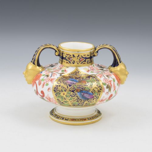fig 1. A Victorian Royal Crown Derby porcelain vase featuring twin gilded mask handles, intricate cobalt blue and gold panel decoration, and hand-painted floral motifs.