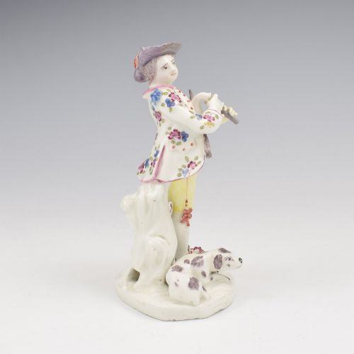 fig 2. An eighteenth-century Bow porcelain figurine depicting a young shepherd playing a pipe alongside a small dog on a sculpted base.