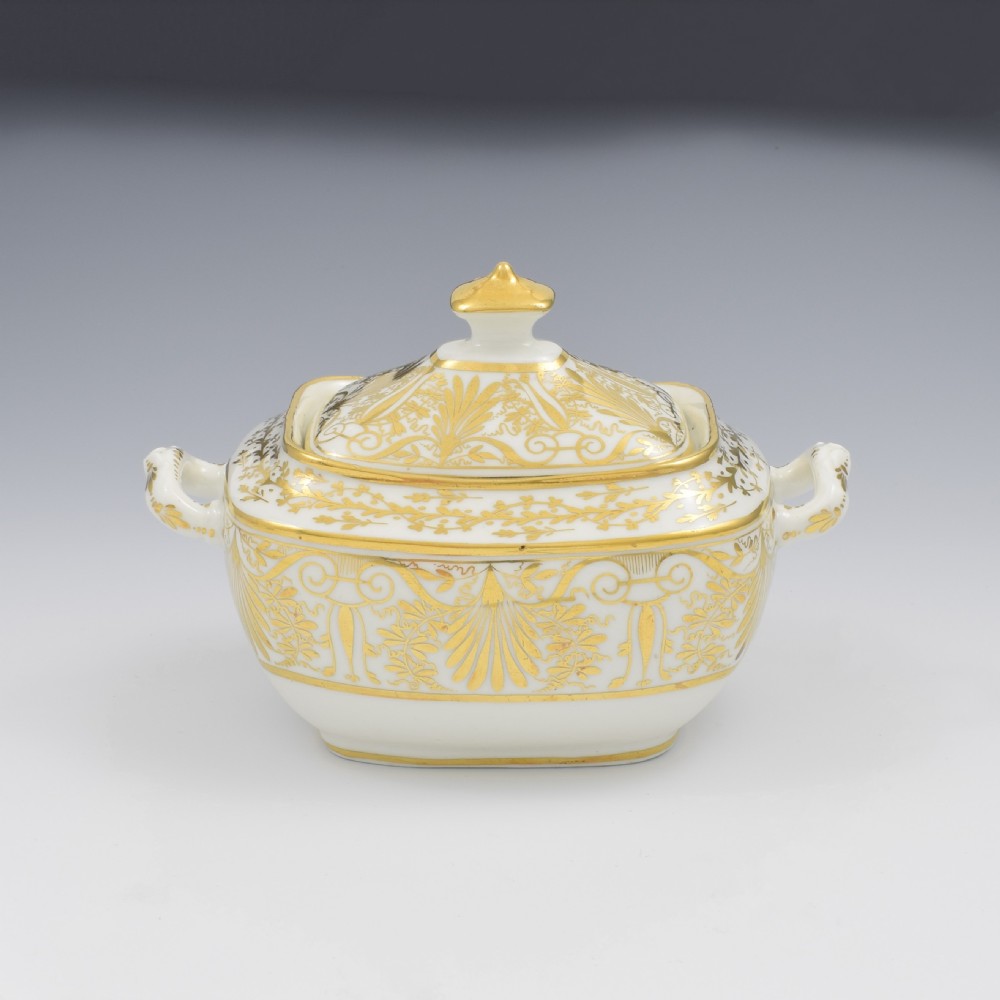 A white and gold Regency Spode porcelain sugar box with original lid, featuring loop handles and Neoclassical gilt scroll patterning. View II