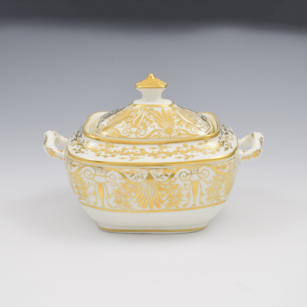 A white and gold Regency Spode porcelain sugar box with original lid, featuring loop handles and Neoclassical gilt scroll patterning. View V