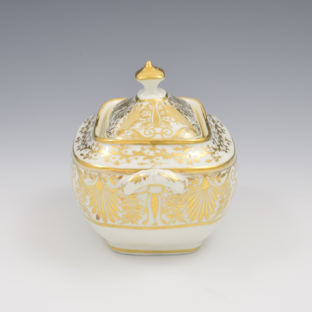 A white and gold Regency Spode porcelain sugar box with original lid, featuring loop handles and Neoclassical gilt scroll patterning. View VII