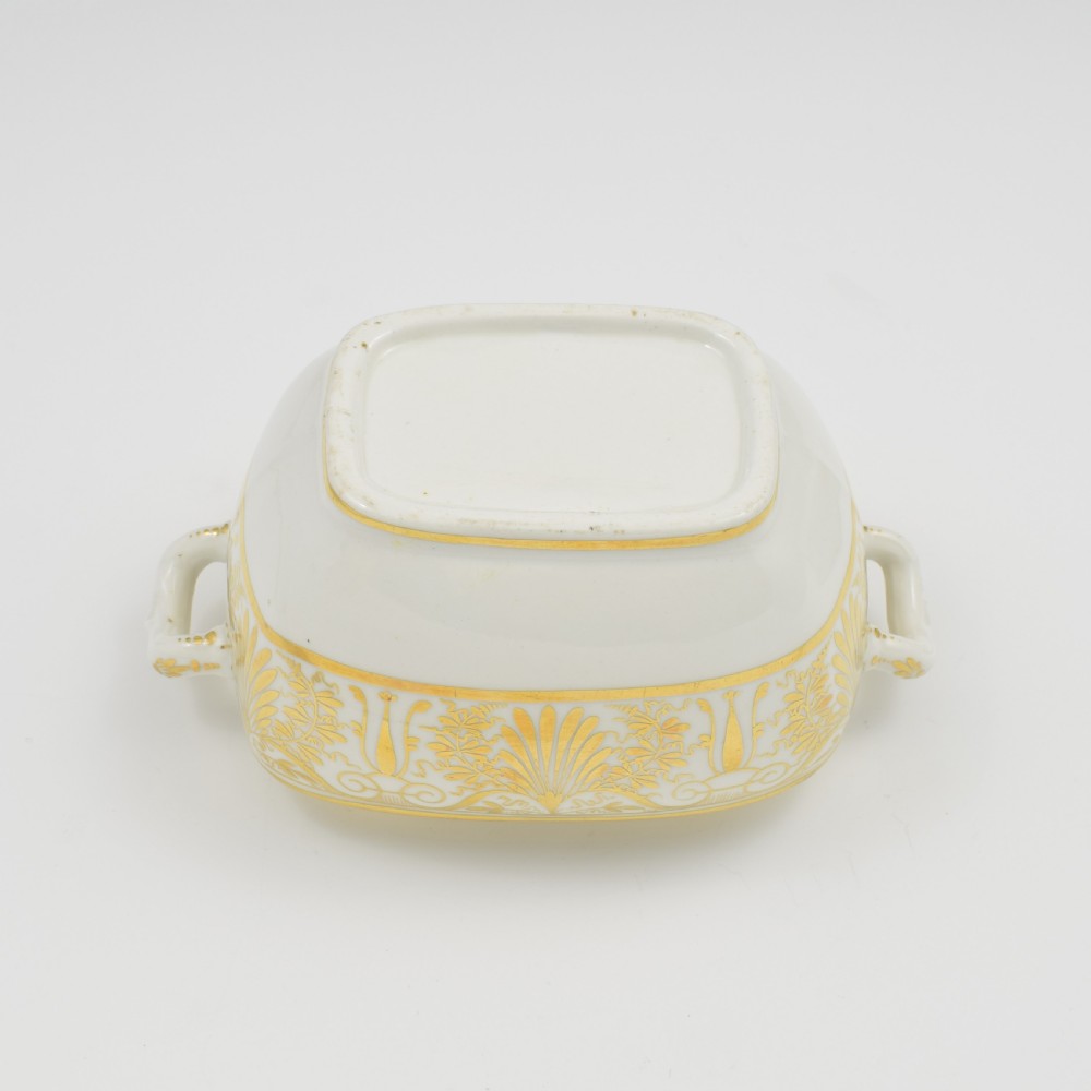A white and gold Regency Spode porcelain sugar box with original lid, featuring loop handles and Neoclassical gilt scroll patterning. View IX