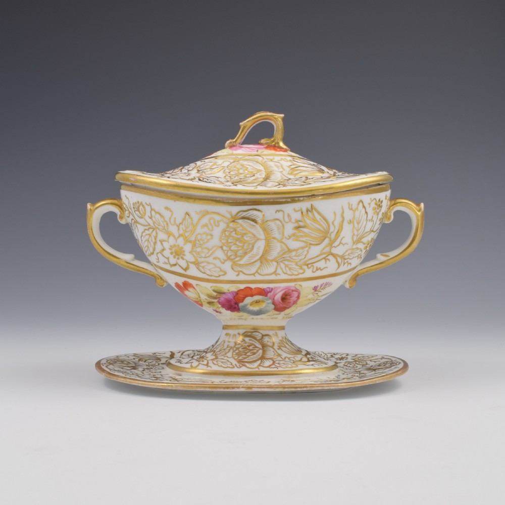 A Regency era white porcelain sauce tureen featuring gilded floral designs, hand-painted botanical flowers, twin side handles, and a matching stand. View III