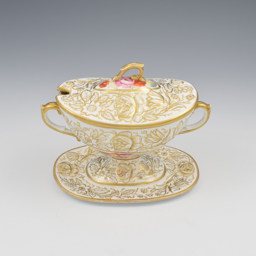 A Regency era white porcelain sauce tureen featuring gilded floral designs, hand-painted botanical flowers, twin side handles, and a matching stand. View VIII