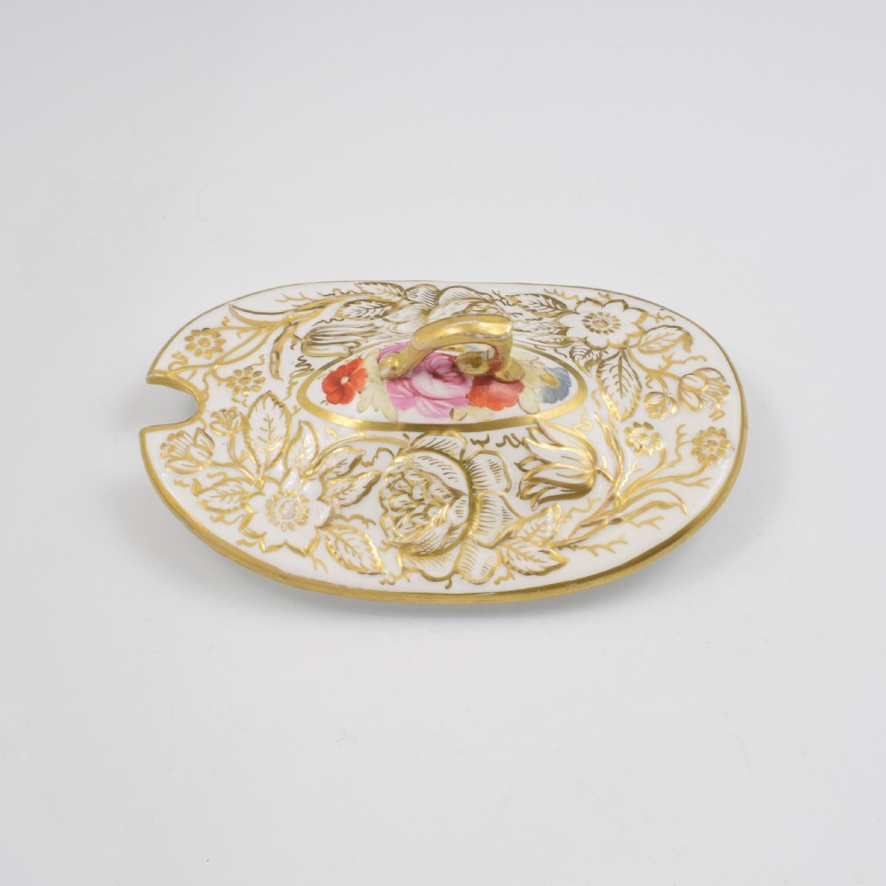 A Regency era white porcelain sauce tureen featuring gilded floral designs, hand-painted botanical flowers, twin side handles, and a matching stand. View X