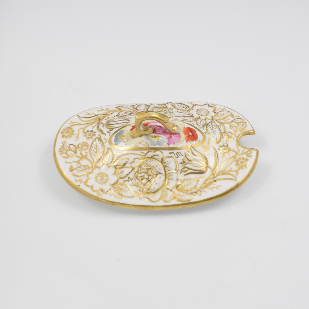 A Regency era white porcelain sauce tureen featuring gilded floral designs, hand-painted botanical flowers, twin side handles, and a matching stand. View XI