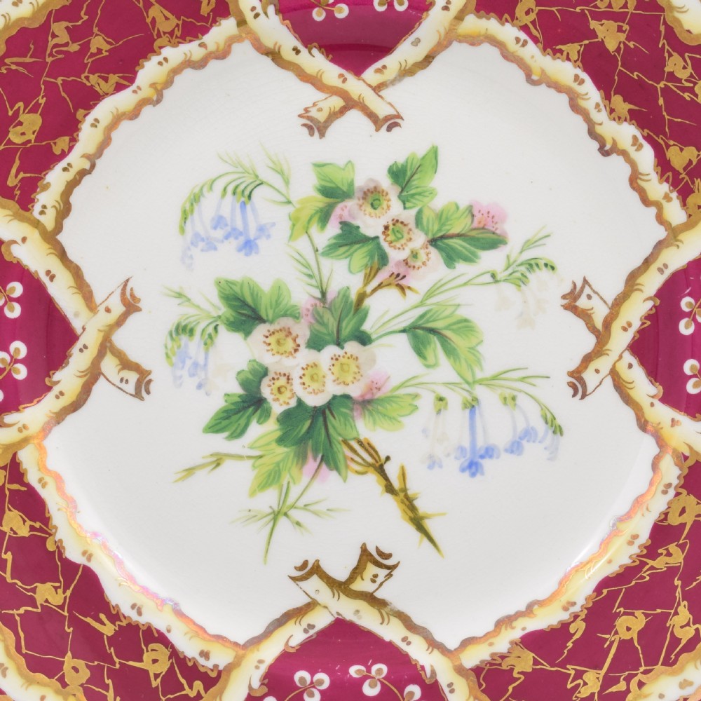 A circular Samuel Alcock porcelain dessert plate featuring a hand-painted botanical floral centre framed by a burgundy and gilt border. View II
