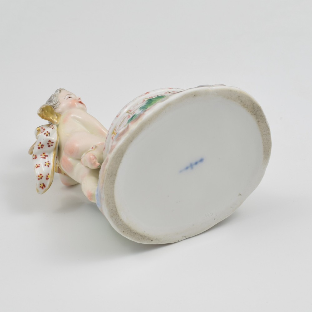 A 19th-century KPM Berlin porcelain table salt featuring a cupid figure standing beside a brick-patterned well basin with hand-painted details. View XIII