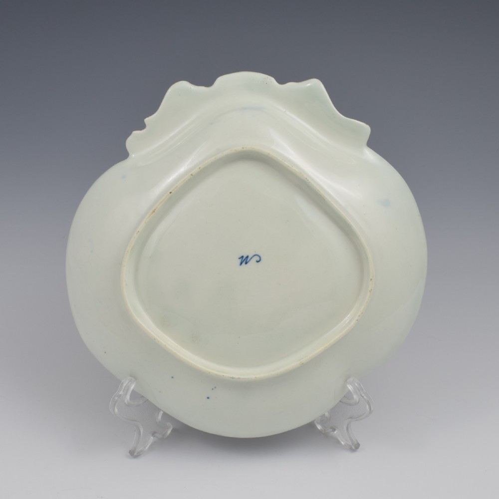 An eighteenth-century shell-shaped soft-paste porcelain dessert dish featuring a hand-painted exotic bird, floral motifs, and a cobalt blue border detailed with gilded lattice work. View VI