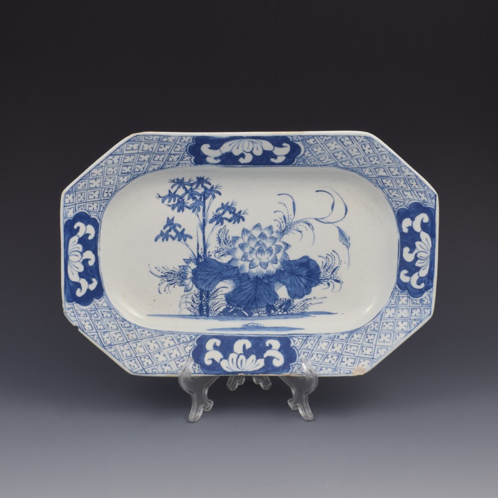 An 18th-century octagonal blue and white soft-paste porcelain serving dish decorated with a central lotus and bamboo design within a diaper border. View II