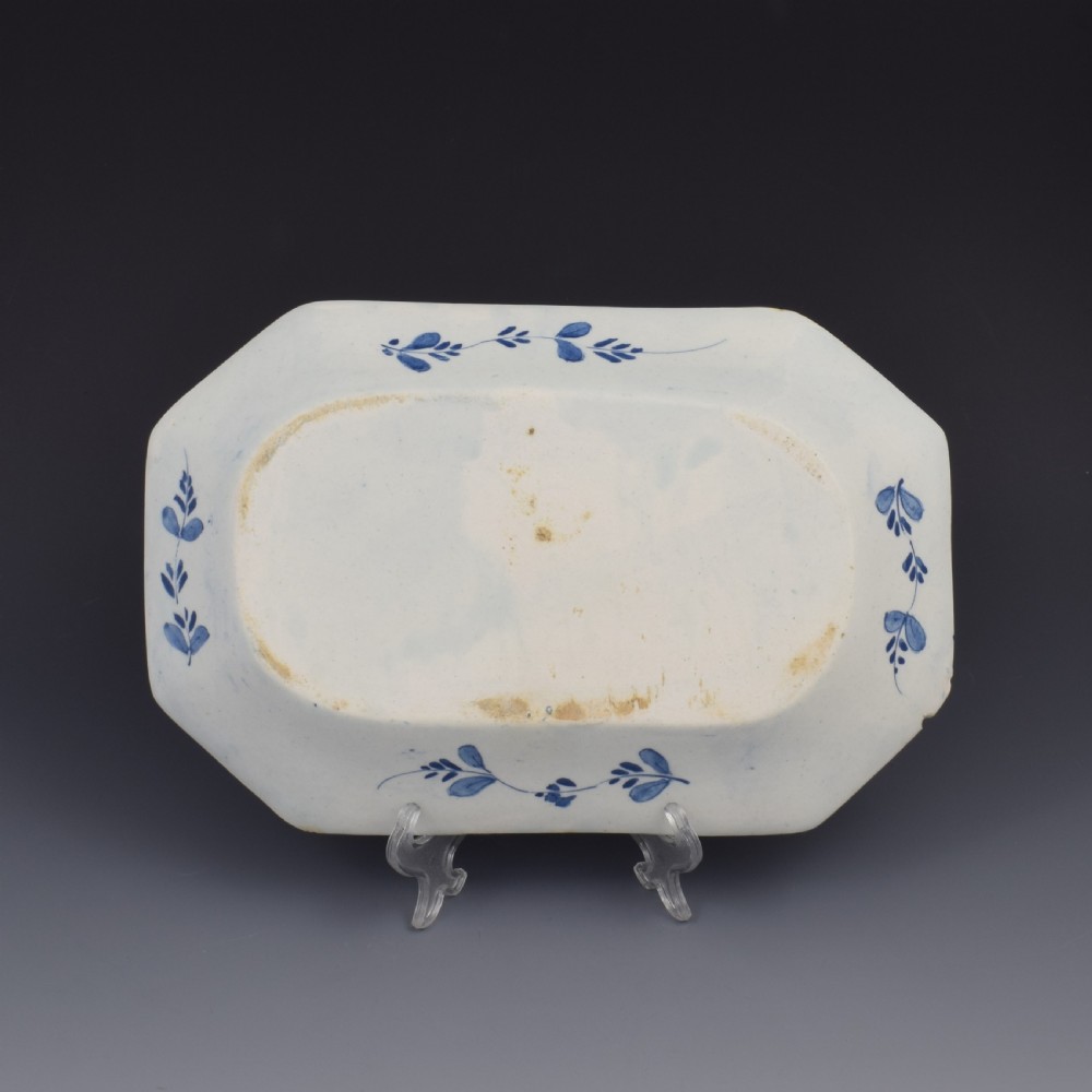 An 18th-century octagonal blue and white soft-paste porcelain serving dish decorated with a central lotus and bamboo design within a diaper border. View III
