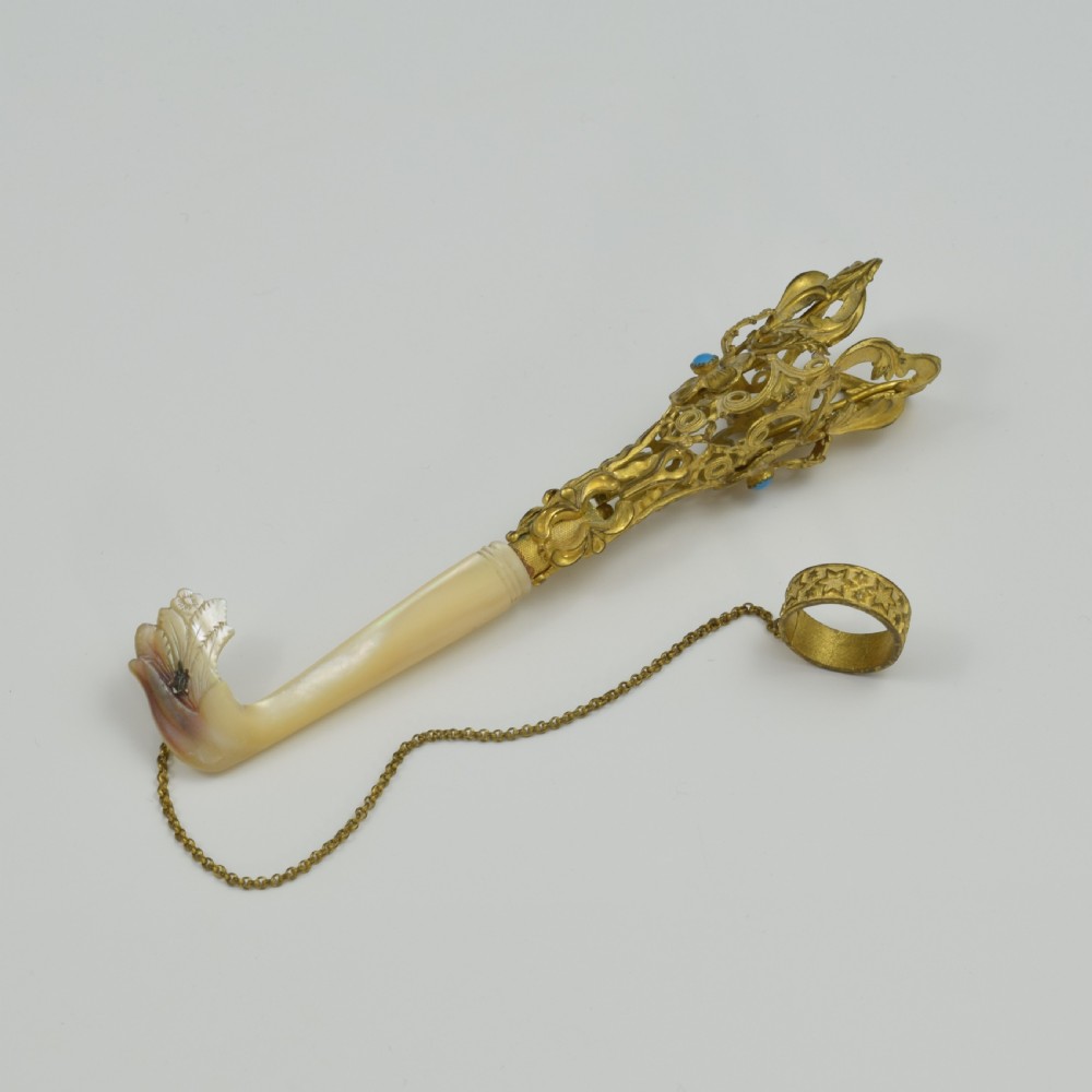 An antique French gilt ormolu tussie mussie posy holder featuring elaborate pierced metalwork set with a turquoise stone, a carved mother-of-pearl handle, and a finger ring attached by a chain. View VI