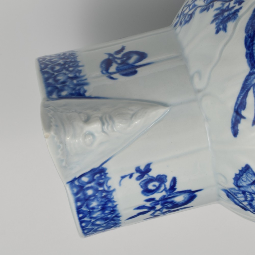 An 18th-century First Period Worcester soft-paste porcelain mask jug featuring cabbage-leaf moulding and blue and white printed foliage motifs. View IX