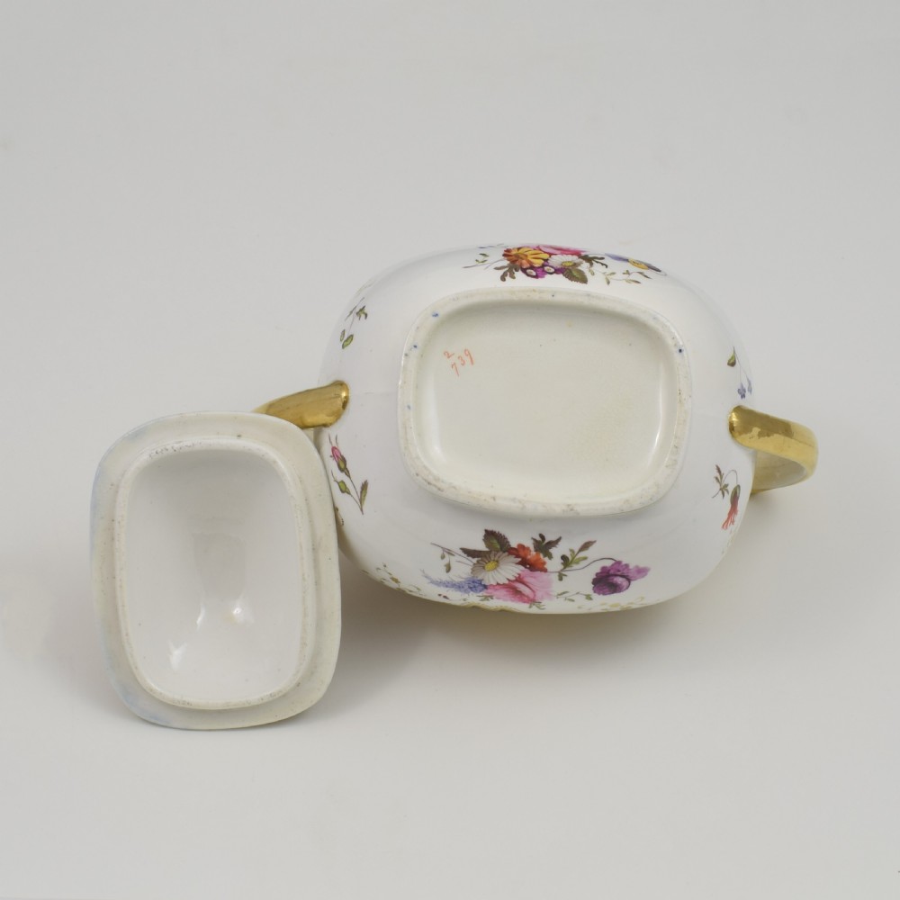 A Regency period lidded porcelain sucrier featuring twin handles, cobalt blue borders decorated with gilt Greek key scrolling, and hand-painted floral sprays. View XIV