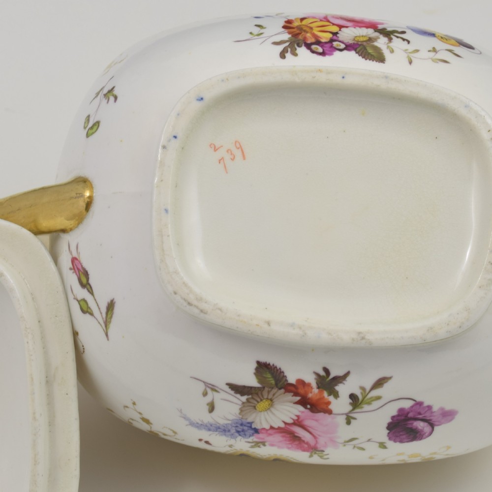 A Regency period lidded porcelain sucrier featuring twin handles, cobalt blue borders decorated with gilt Greek key scrolling, and hand-painted floral sprays. View XV