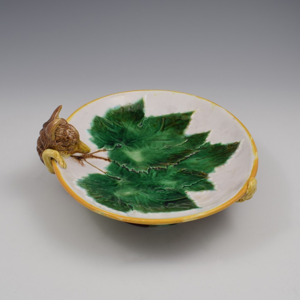 An oval Victorian majolica dish featuring a pink interior ground with raised green leaves and a sculpted fox head perched on the rim. View IV