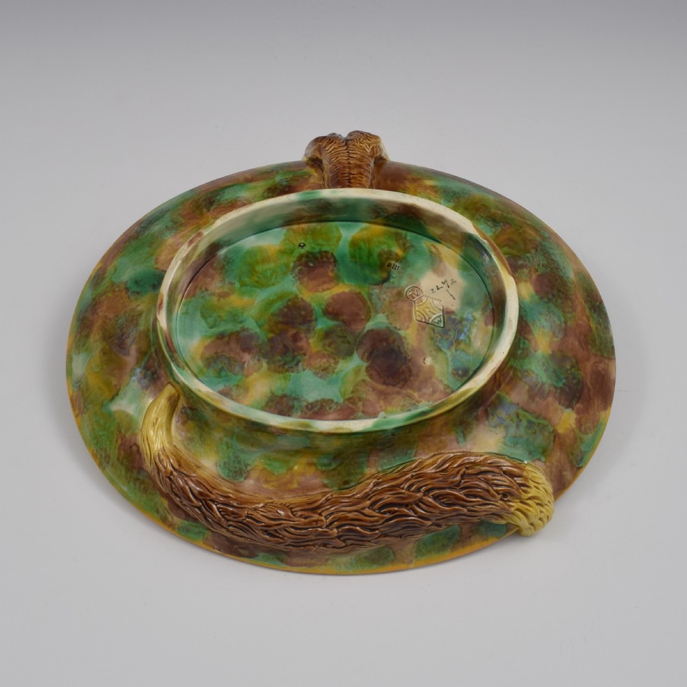 An oval Victorian majolica dish featuring a pink interior ground with raised green leaves and a sculpted fox head perched on the rim. View XII
