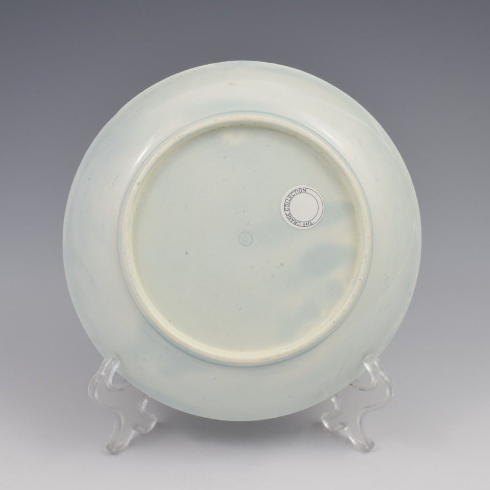 A circular eighteenth-century Worcester porcelain saucer dish decorated with a hand-painted bird in a central medallion, fruit garlands, and a gilded cobalt blue border. View III