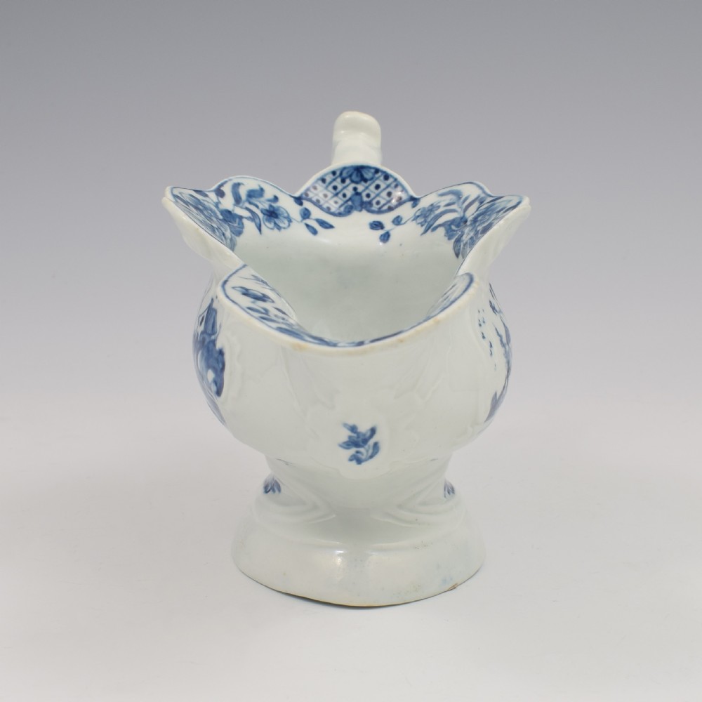 An 18th-century First Period Worcester soft-paste porcelain sauce boat decorated with a hand-painted blue and white chinoiserie landscape motif. View III