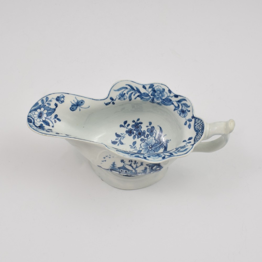 An 18th-century First Period Worcester soft-paste porcelain sauce boat decorated with a hand-painted blue and white chinoiserie landscape motif. View XI