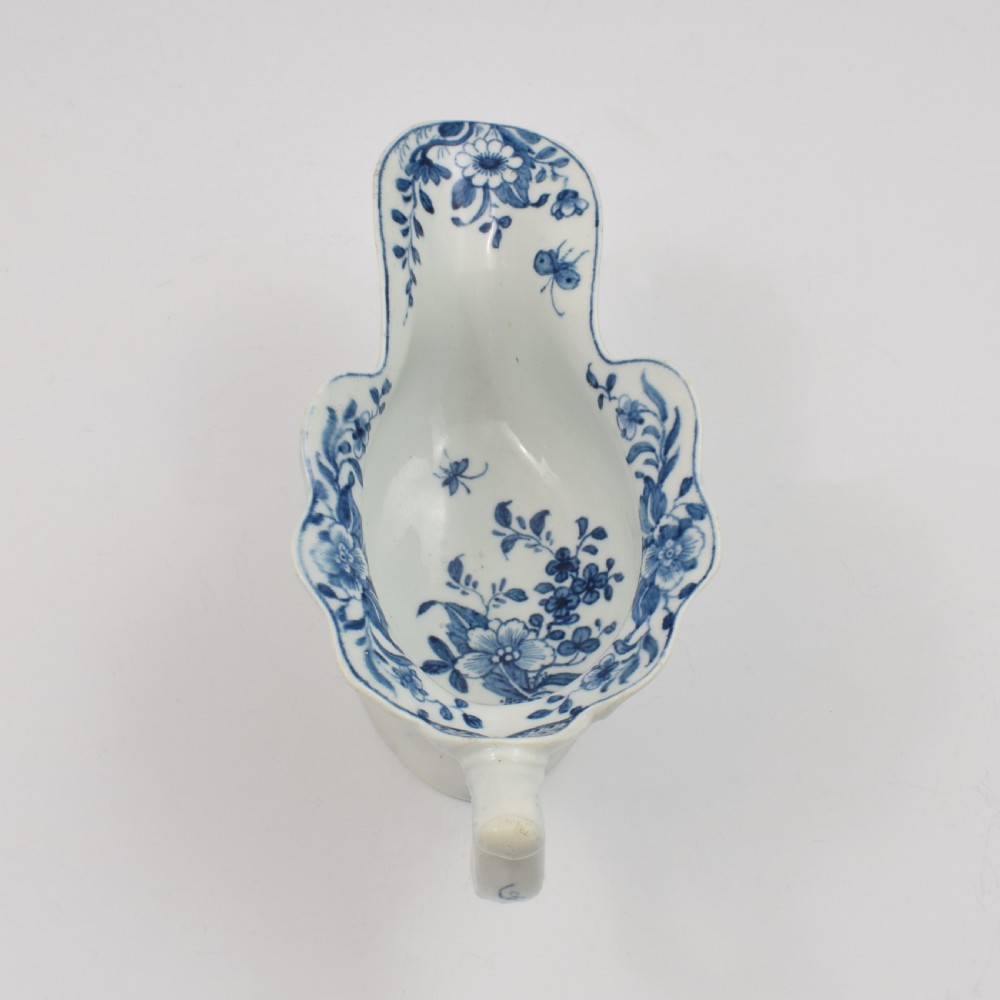 An 18th-century First Period Worcester soft-paste porcelain sauce boat decorated with a hand-painted blue and white chinoiserie landscape motif. View XII
