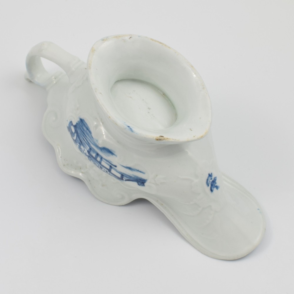 An 18th-century First Period Worcester soft-paste porcelain sauce boat decorated with a hand-painted blue and white chinoiserie landscape motif. View XIV
